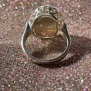 Sterling silver ring with gold colored background inside the cage.